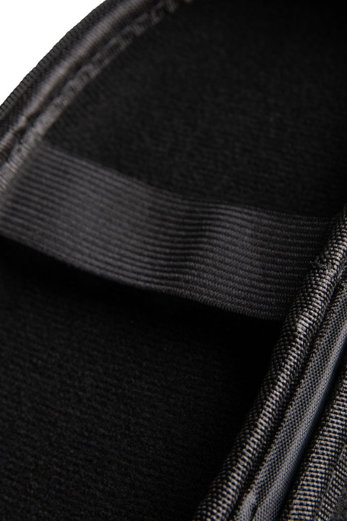 Arena Goggle Case in black, purple, and black colors, designed to protect and store swimming goggles.