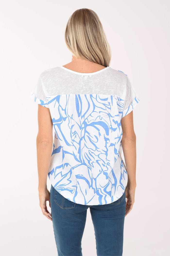 Woman wearing a white t-shirt with blue abstract patterns on a white background