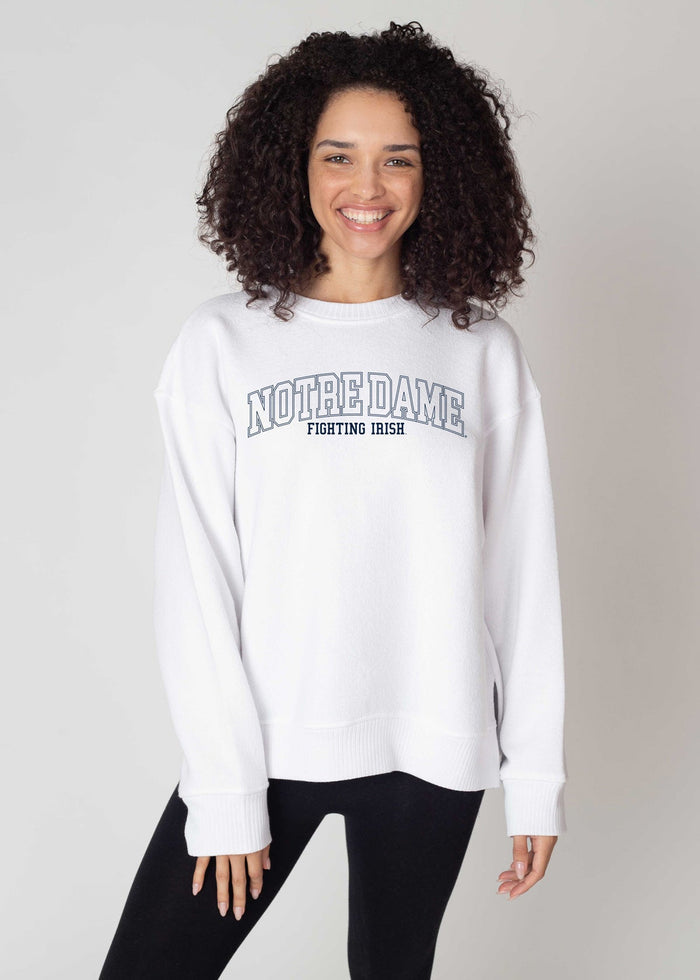 Notre Dame Fighting Irish Women's White Relaxed Brushed fleece Sweatshirt with Drop shoulders, ribbed hemline, cuffs, and neckline, along with side slits and a high-low hem.