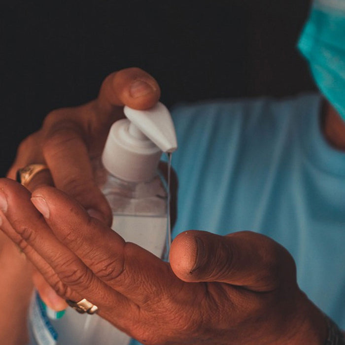 Medical practitioner applying Superbug 70% alcohol hand sanitiser gel with added tea tree essential oils to their hands