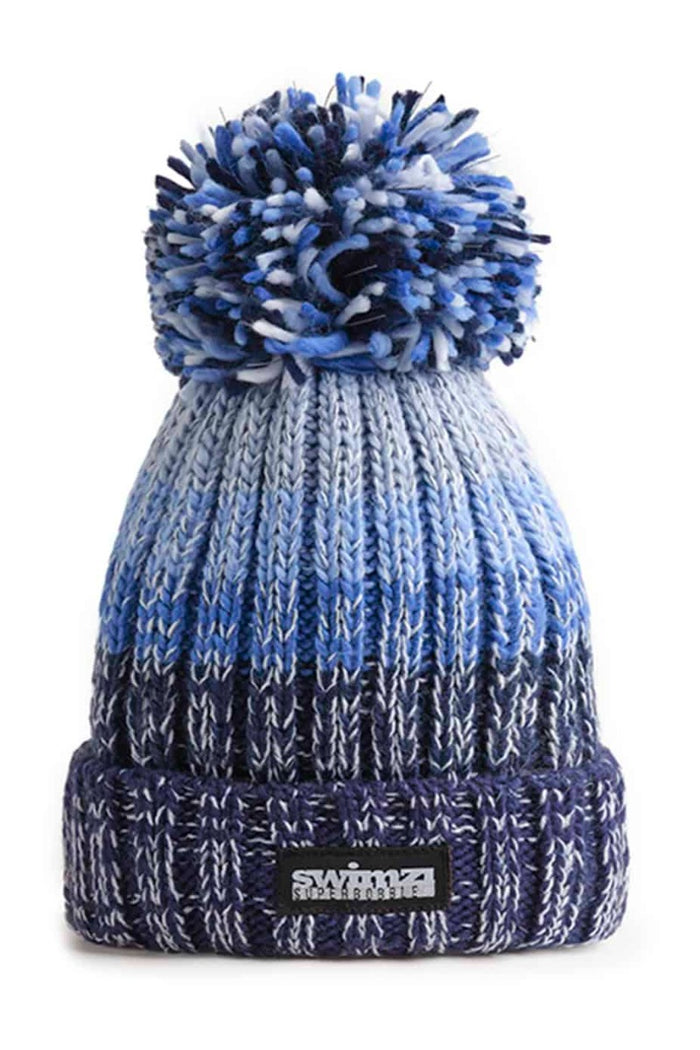 Swimzi blue gradient super bobble hat, a cozy knit hat with a large fluffy pom-pom on top, perfect for cold weather.