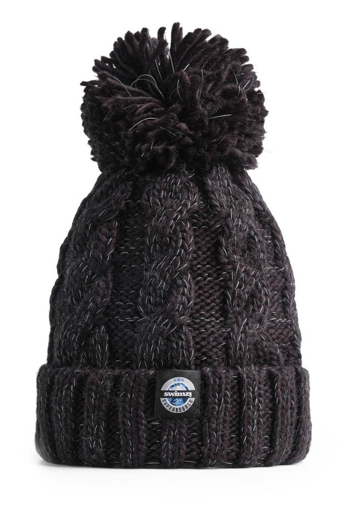 Swimzi Jet Black Cable Knit Super Bobble Hat, a black knit winter hat with a large bobble, designed for warmth and style.