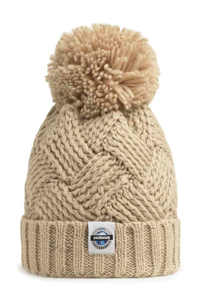Swimzi Oatmeal Patchwork Reflective Super Bobble Hat in brown, a cozy knit cap with a large bobble and reflective accents.