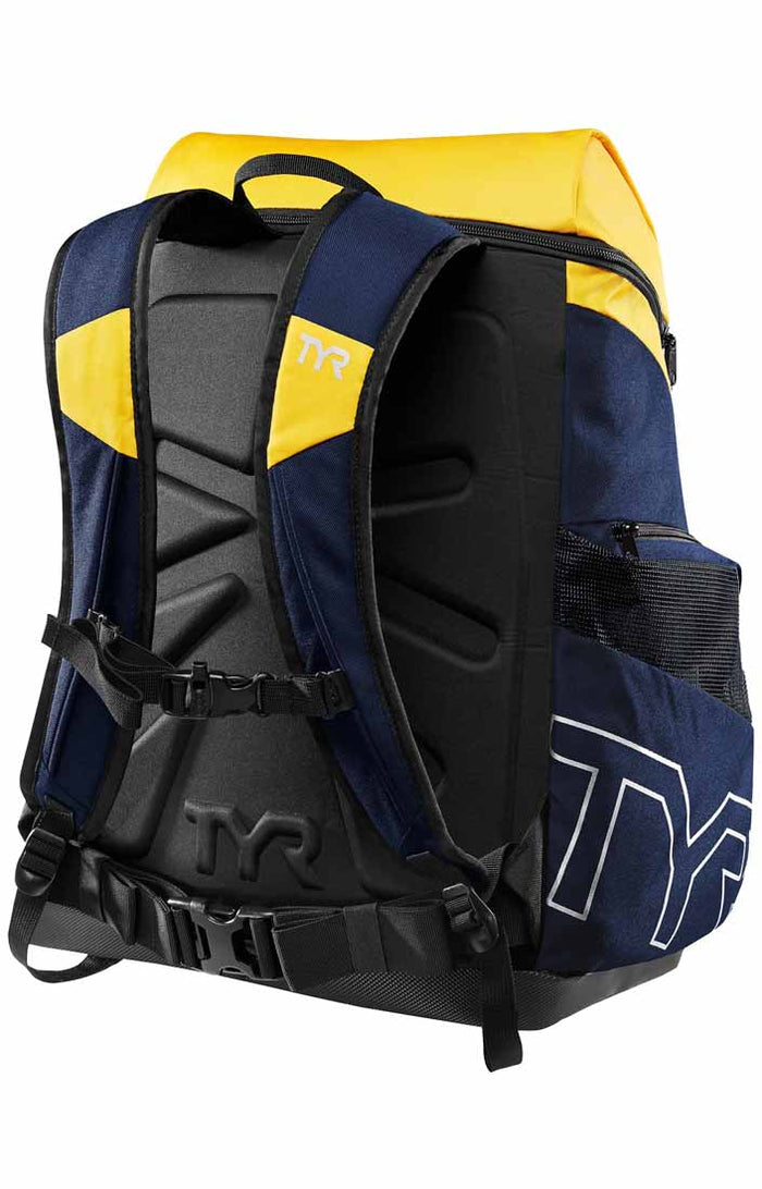TYR Alliance 45L backpack in navy and gold with multiple compartments and padded straps, designed for sports and travel use.