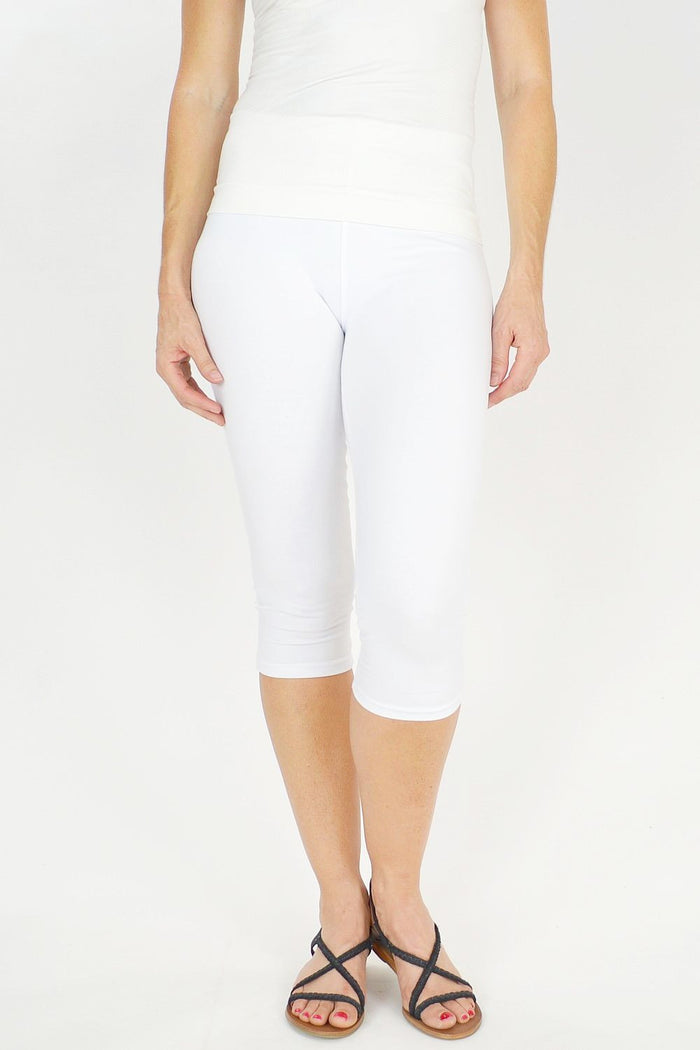 White Lilia 3/4 leggings laid flat, showcasing the soft fabric, snug fit, and clean design ideal for active or casual wear.