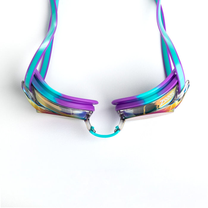 Zoggs Racer Titanium mirrored goggles in violet, turquoise, and blue, with reflective lenses and adjustable straps for swimming.