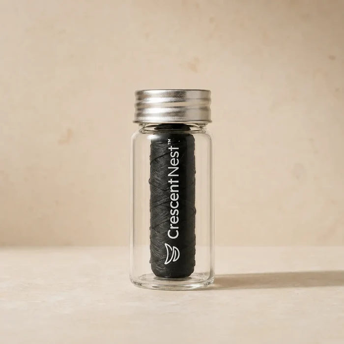 Crescent Nest bamboo charcoal dental floss in a reusable glass jar