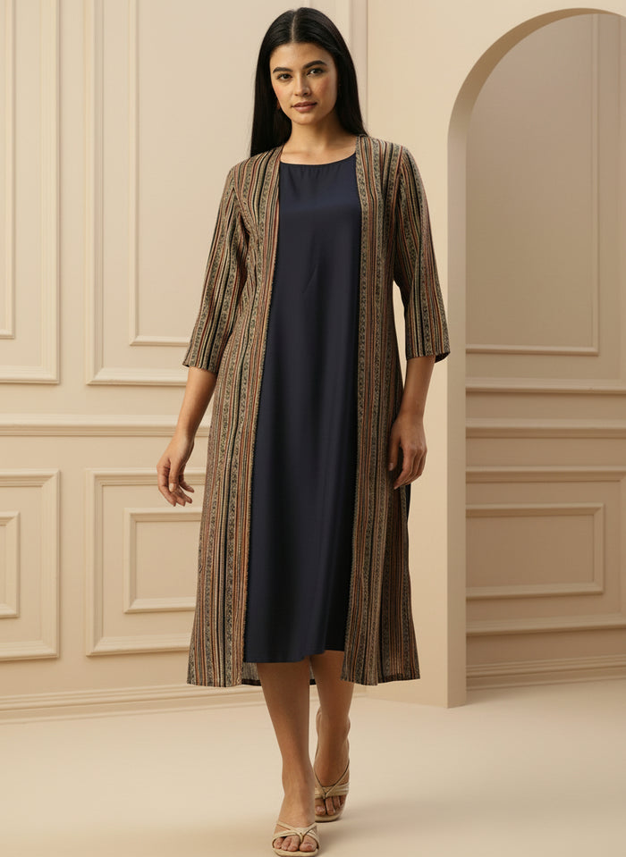 Woman wearing a navy dress with a patterned cardigan in a neutral setting , Beige Striped Printed Dress ,midi dress, dress, women’s western wear, party wear dress, casual wear dress