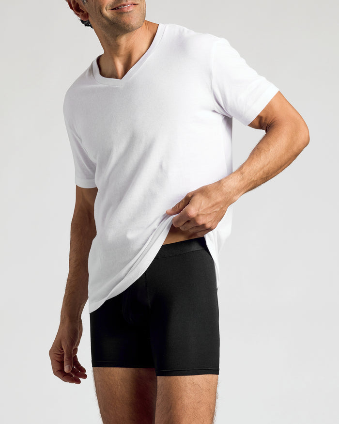 Man lifting white shirt to reveal Black Boxer Briefs underneath.