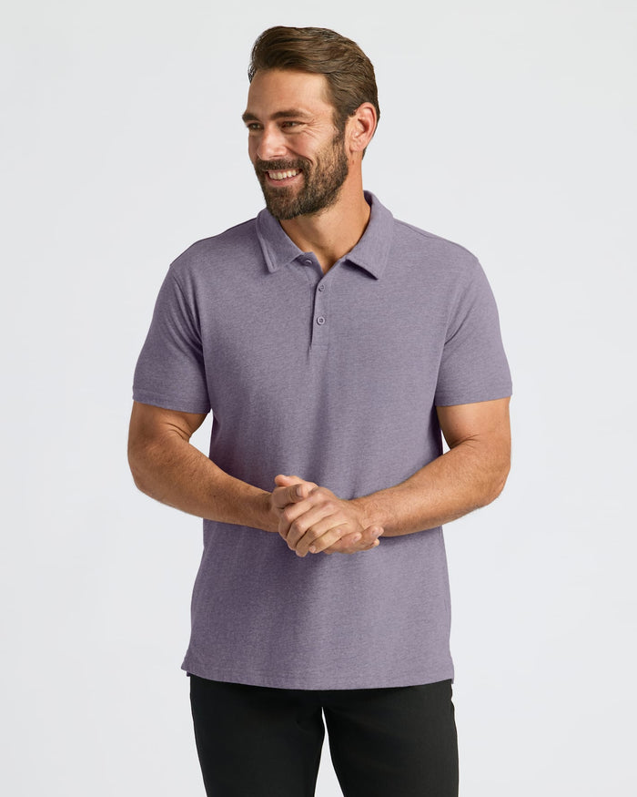 Man wearing Seasonal Classic Polo 3-Pack in heather-purple, smiling against a plain background.