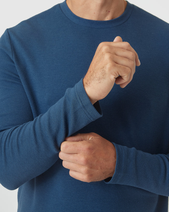 Deep Sea Blue Long Sleeve Waffle Crew being adjusted.