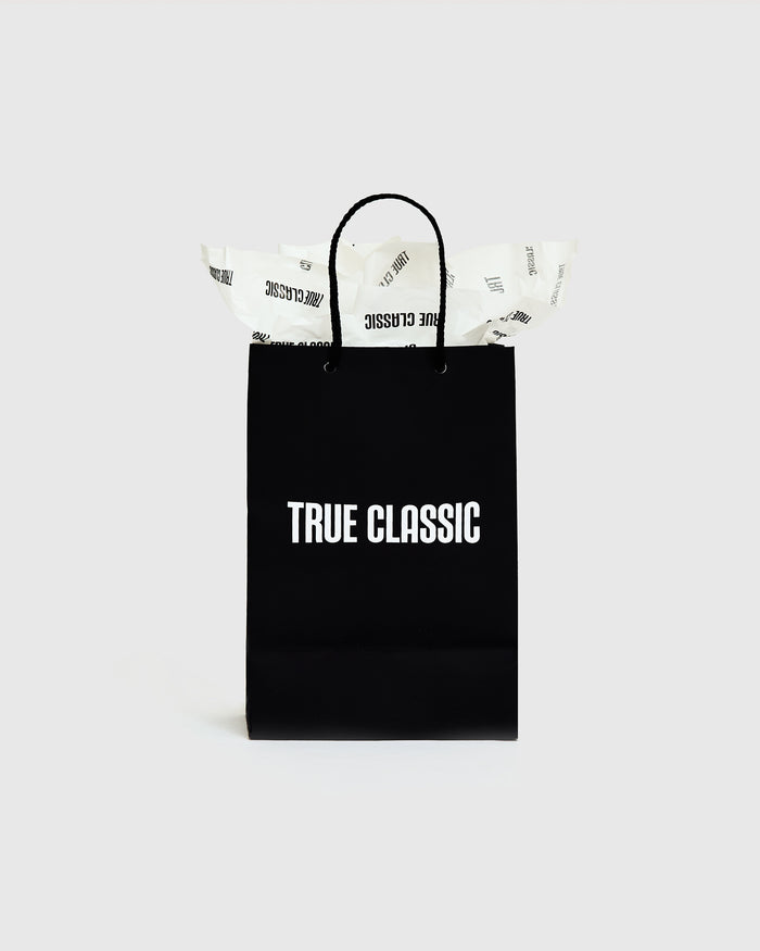 Gift Bag with braided handles and “TRUE CLASSIC” print.