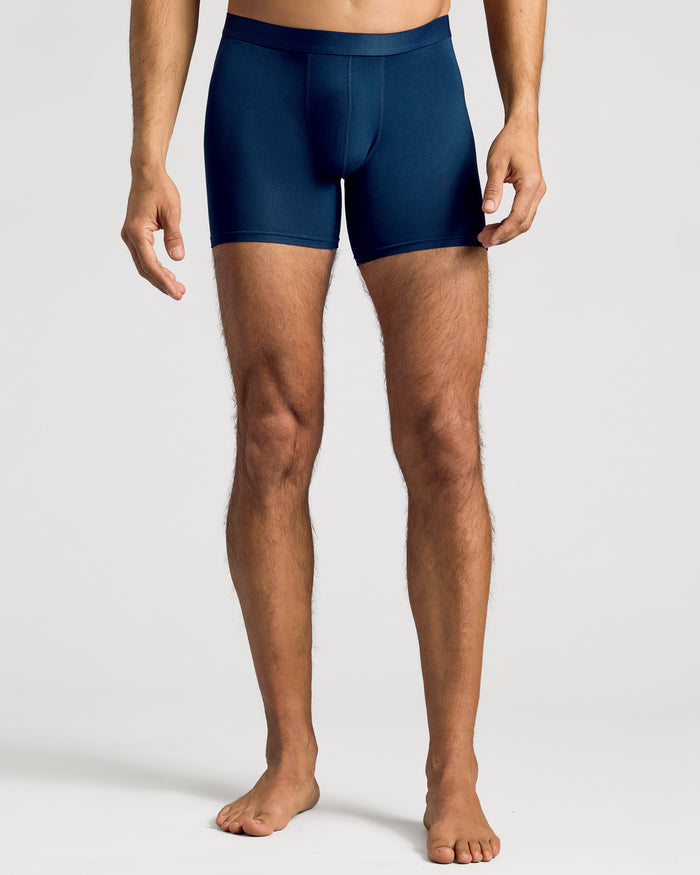 Man wearing navy boxer briefs showing modern fit and elastic waistband.