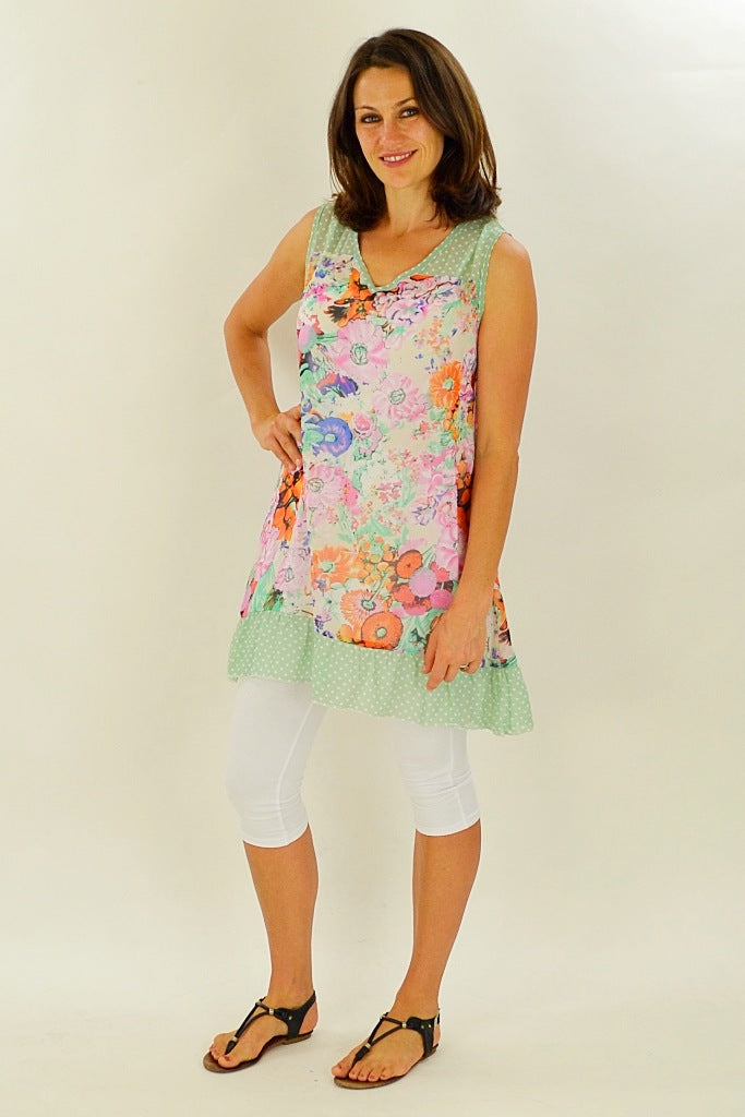 Whispers Orange Meadow Flowers Tunic with vibrant floral pattern, lightweight fabric, and relaxed fit displayed in the image.