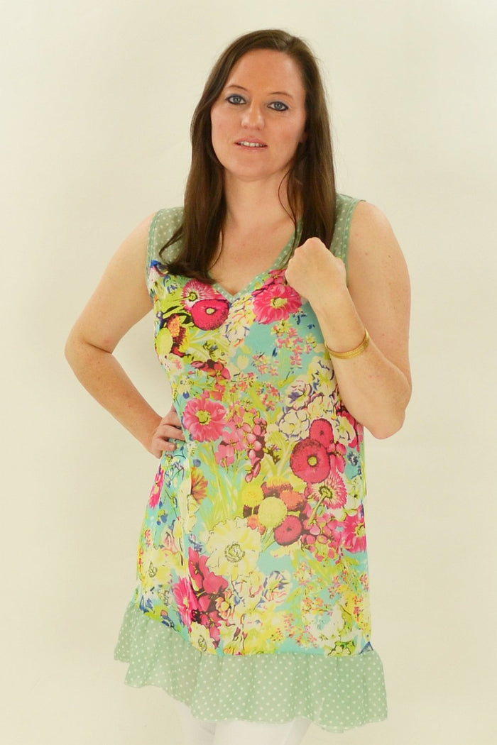 Pink Meadow Flowers tunic by Whispers, featuring a floral pattern and lightweight fabric, displayed on a hanger.