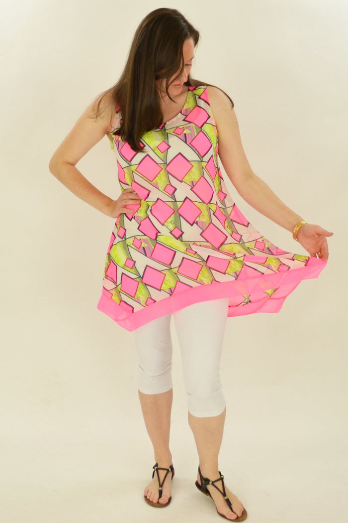 Pink squares pattern Whispers tunic displayed on a hanger, showcasing the casual and stylish design with long sleeves and comfortable fit.