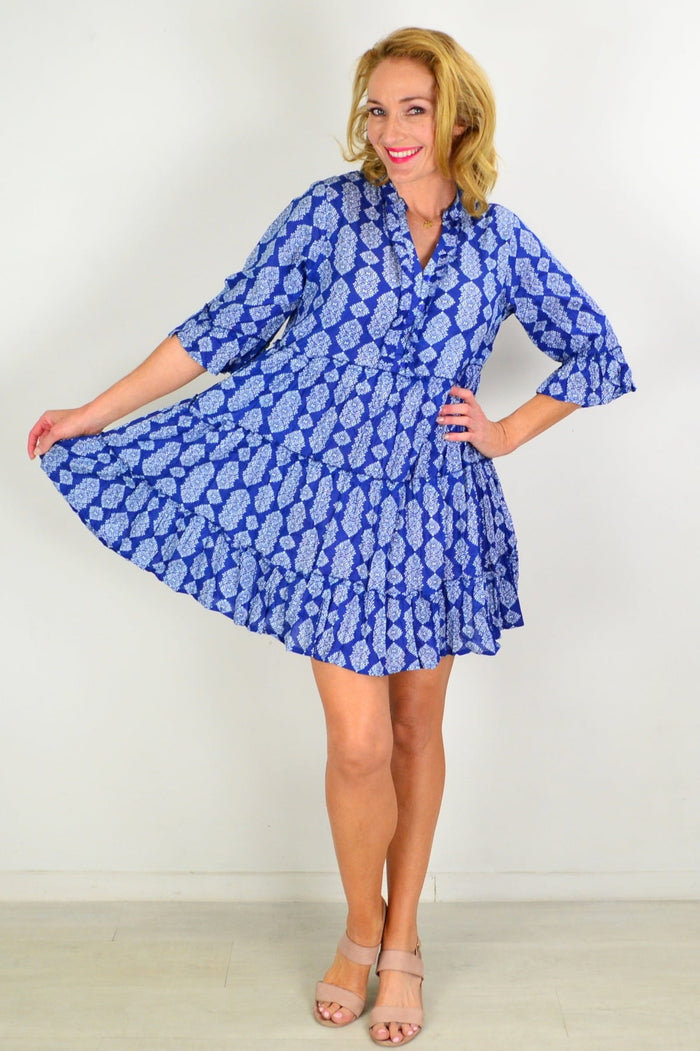 Blue tiered tunic dress by One Summer, featuring flowing fabric and layered design, displayed on a hanger against a neutral background.