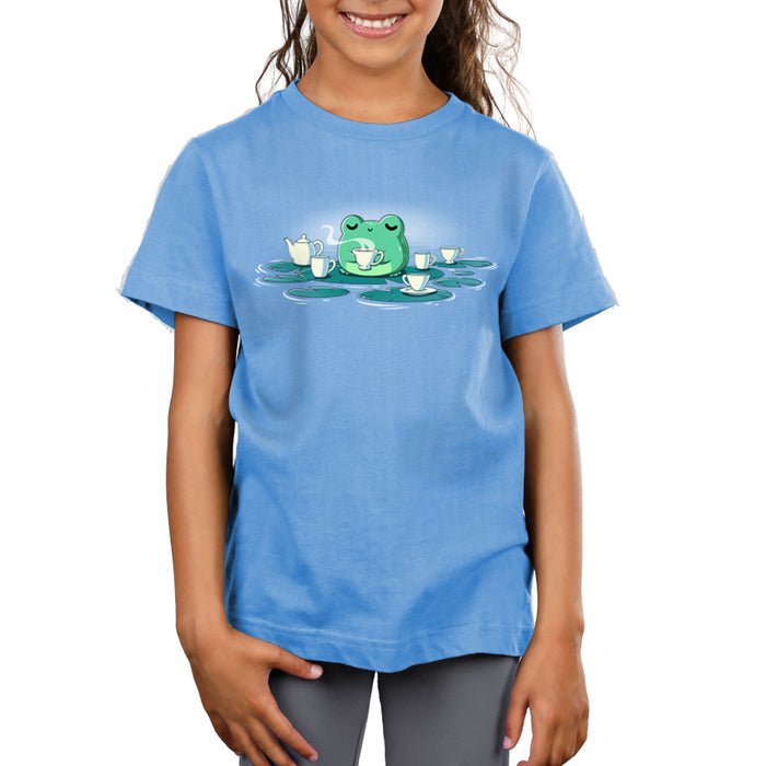 Premium Cotton T-shirt_TeeTurtle light blue Ribbit and Sip apparel featuring a frog drinking coffee sitting on a lily pad surrounded by lily pads with coffee cups on them.