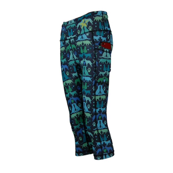 Women's Capri leggings with blue and green dog print and side pocket holding a red phone