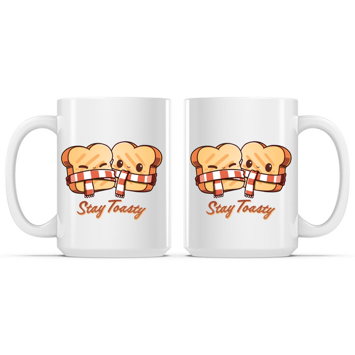 Ceramic Mug_TeeTurtle Stay Toasty Mug white mug featuring two smiling slices of toast wrapped together in a cozy striped scarf above the phrase "Stay Toasty."