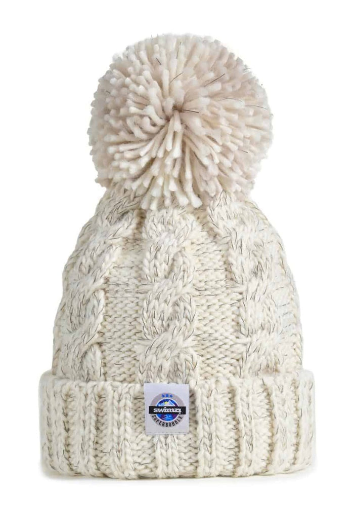 Swimzi oatmeal cable knit super bobble hat in brown, a cozy knit hat with a large bobble, perfect for winter warmth and style.