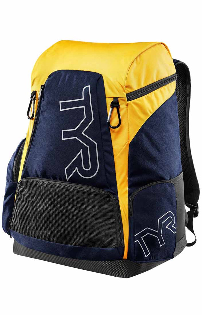 TYR Alliance 45L backpack in navy with gold accents, featuring multiple compartments and adjustable straps for sports and travel.