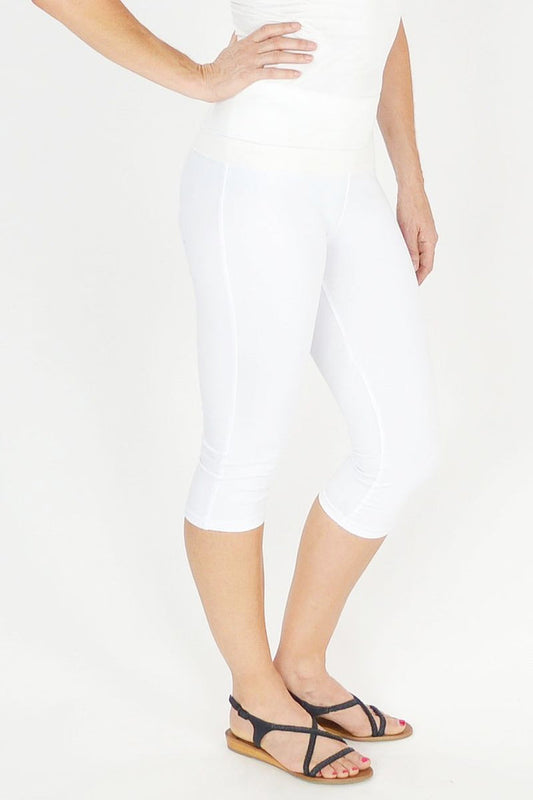 White Lilia 3/4 leggings displayed on a model, showing their slim fit and comfortable stretchy fabric.